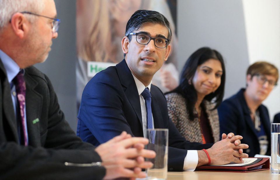 Britain's Prime Minister Rishi Sunak (2L), and Britain's Home Secretary Suella Braverman (2R) sit with National Society for the Prevention of Cruelty to Children (NSPCC) CEO Peter Wanless (L) take part in a meeting of the Grooming Gang Taskforce, during a visit to the offices of the NSPCC in Leeds, northern England, on April 3, 2023. (Photo by Lindsey Parnaby / POOL / AFP) (Photo by LINDSEY PARNABY/POOL/AFP via Getty Images)