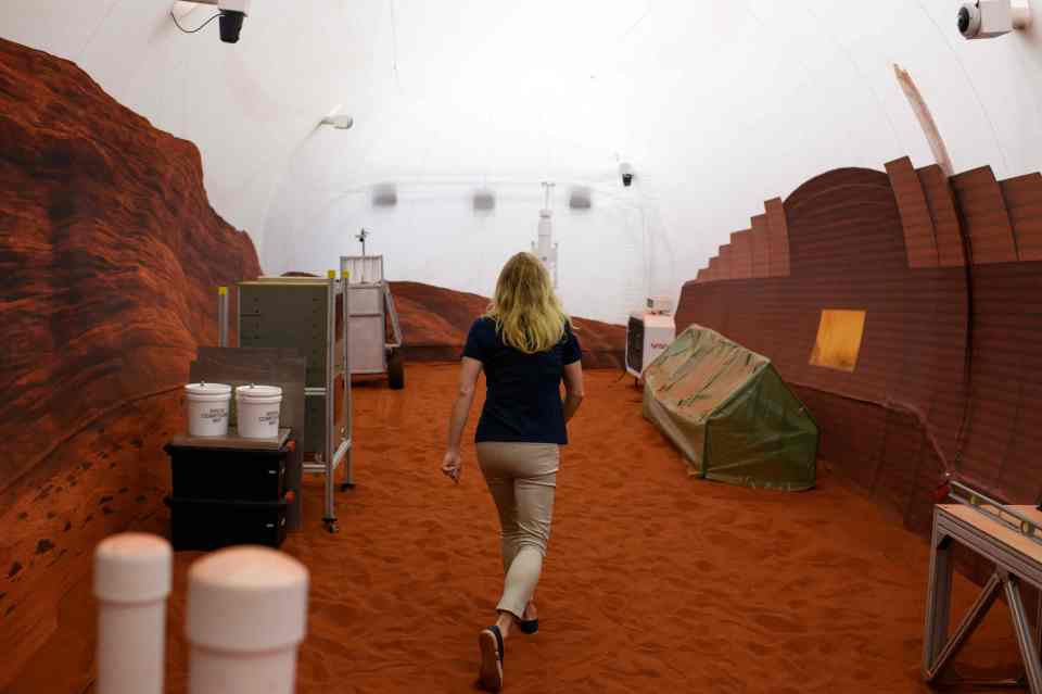 Dr. Suzanne Bell, Lead for NASA's Behavioral Health and Performance Laboratory, walking through the simulated Mars exterior area