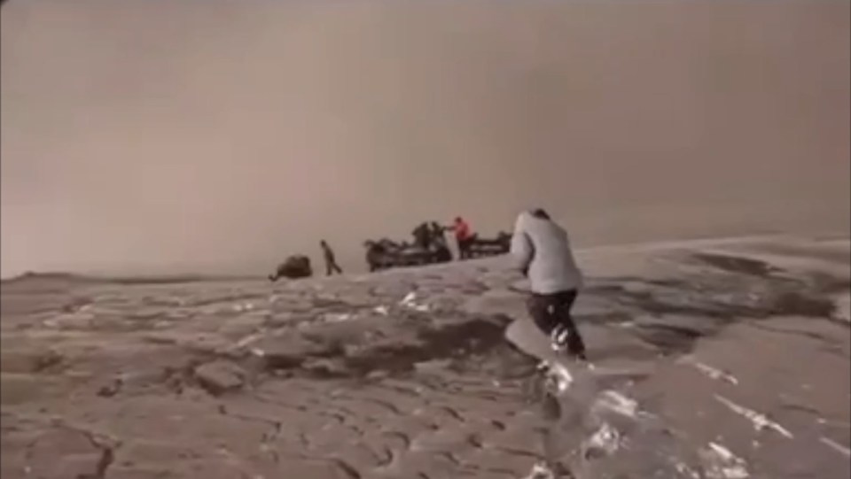 The crazy risky footage captures the ash begin to fall onto them