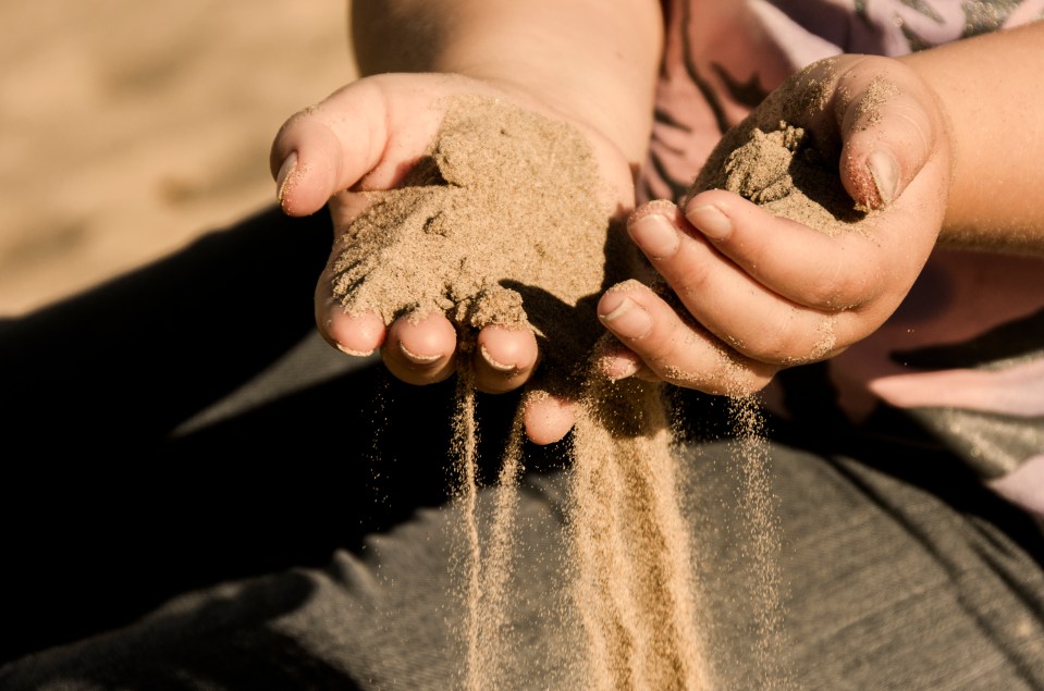 Removing sand from hands and feet can feel like an impossible task