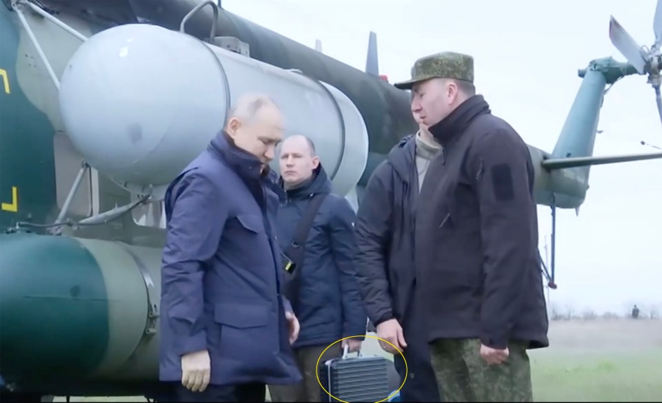 The nuclear briefcase appears to be carried by an aide