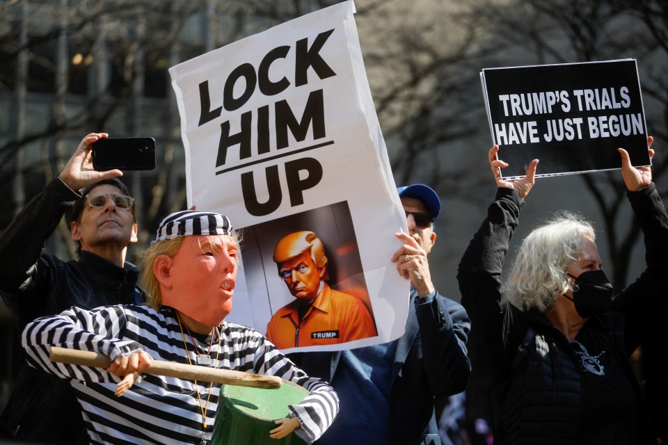 Anti-Trump protester in a prison outfit outside the court