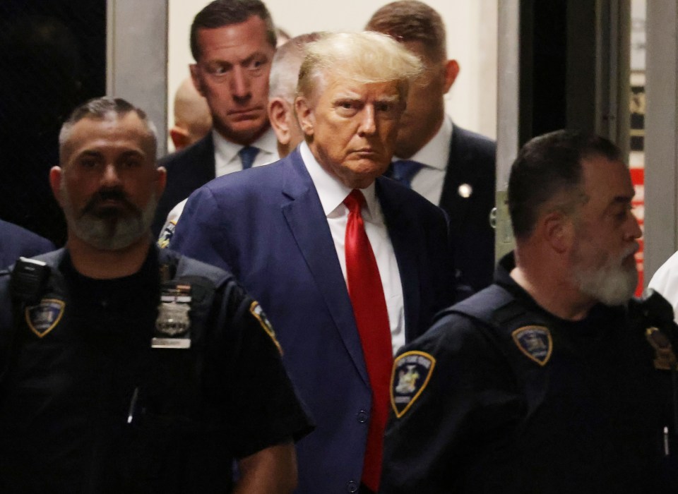 Trump was wearing his trademark red tie and dark blue suit for the historic court hearing