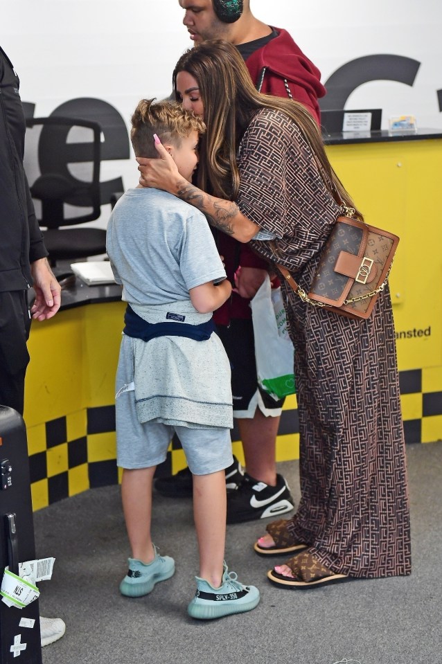 Katie planted a sweet kiss on son Jett's head