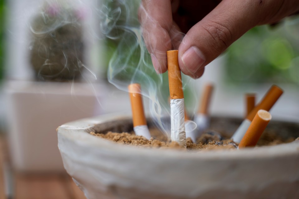 Close up on man Man extinguishes the cigarette in the ash tray quitting no smoking lung health problems