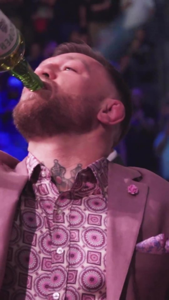 Conor McGregor swigging Proper 12 whiskey from ringside