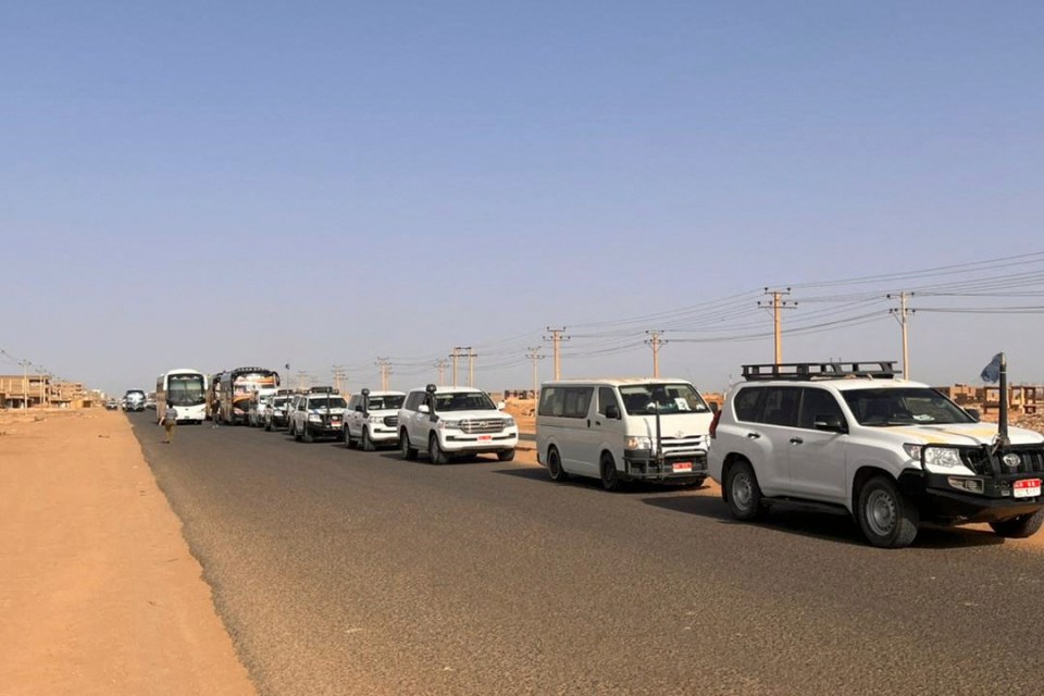 A convoy leaving Khartoum advances on a road towards Port Sudan