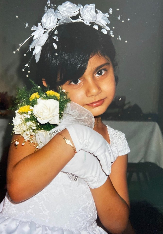 It shows her clutching flowers at her first Holy Communion