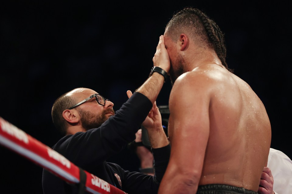 Doctor checks on Joe Joyce’s eye in the corner