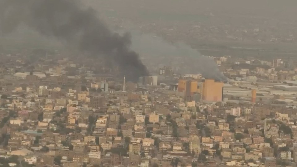 A drone view shows smoke rising over the Khartoum North Light Industrial Area, in Bahri, Sudan