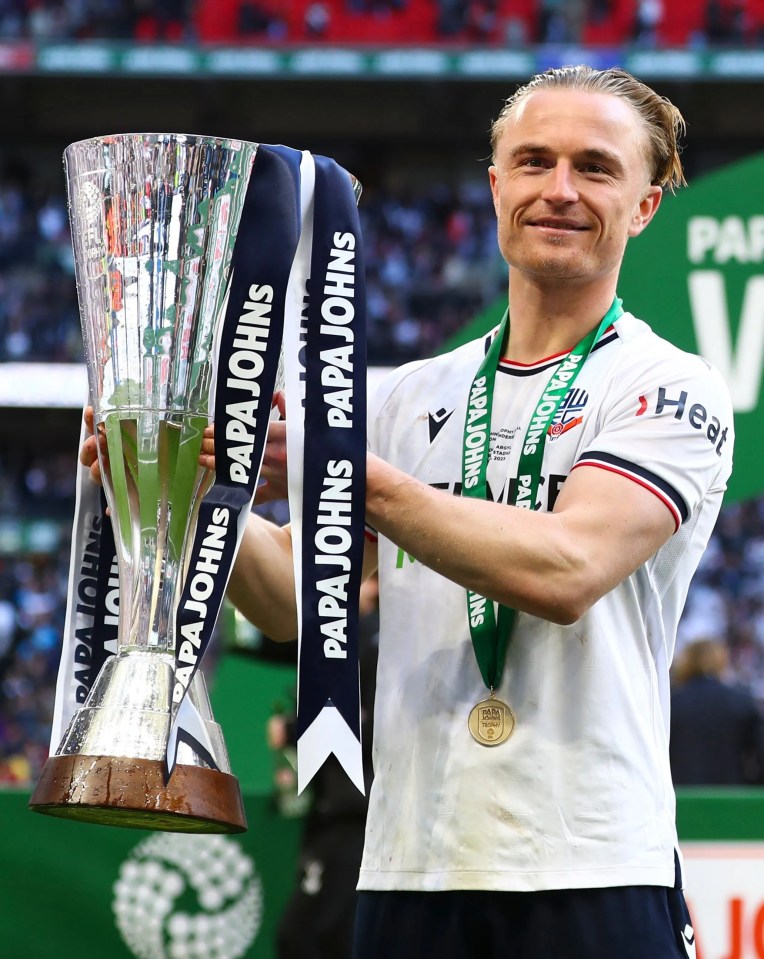 Kyle Dempsey of Bolton Wanderers celebrates with the Papa Johns Trophy earlier in April