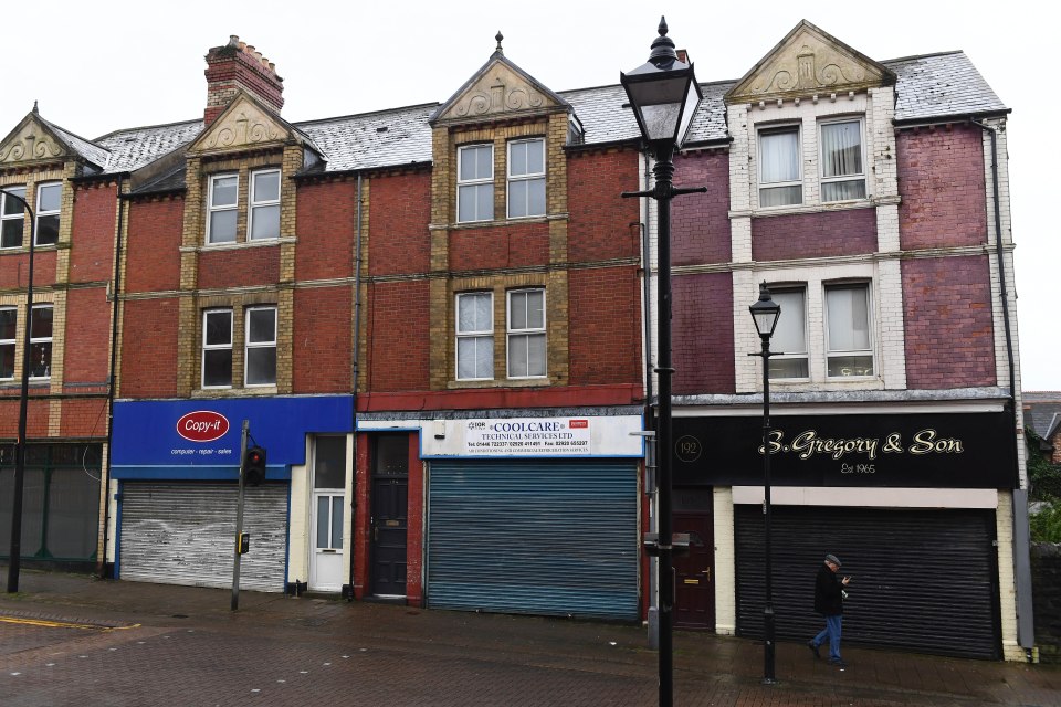 Residents walking past shuttered shops on Holton Road