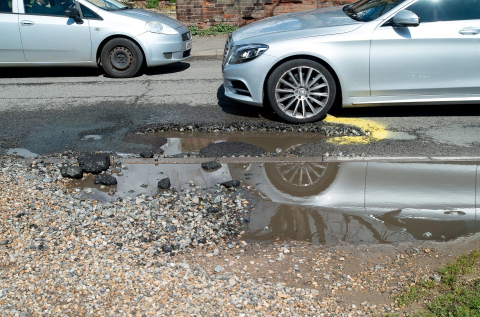 Potholes like this one in Dorney Village, Buckinghamshire are a blight on Britain's roads