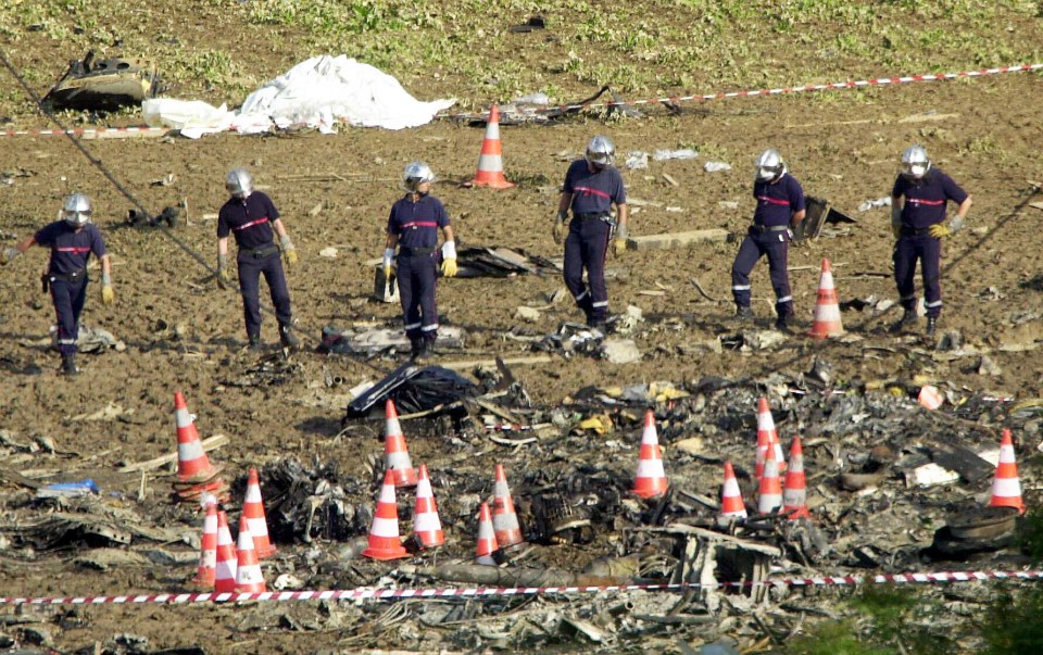 French emergency services sift through the wreckage of the remains of the Air France Concorde aircraft outside Paris in 2000