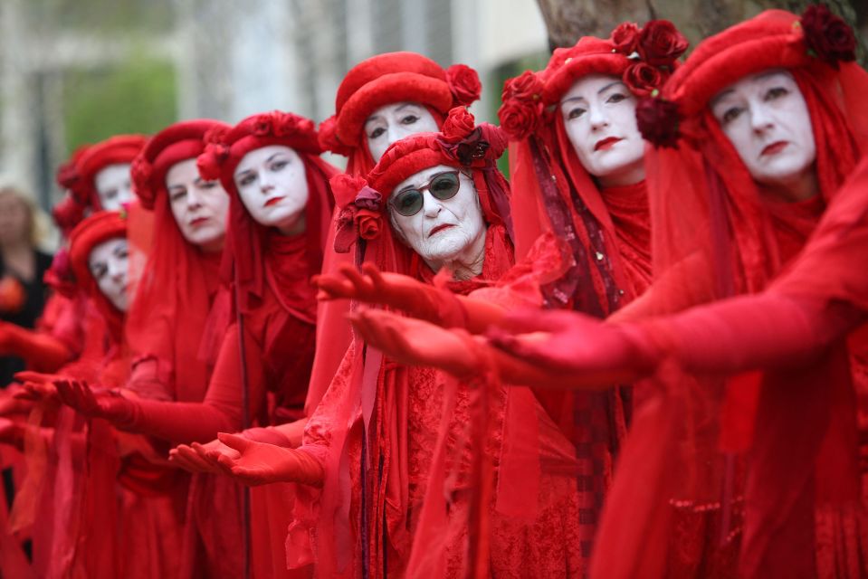 Members of performance troupe Red Rebel Brigade march in central London at a demonstration by the climate change