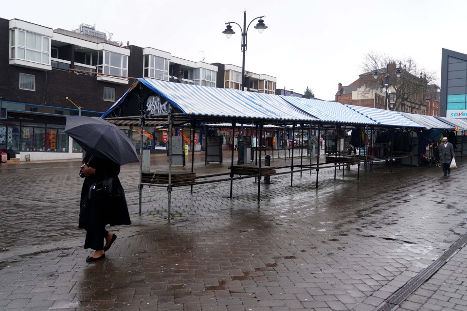 The metal frames set up for market stalls remain empty apart from a few