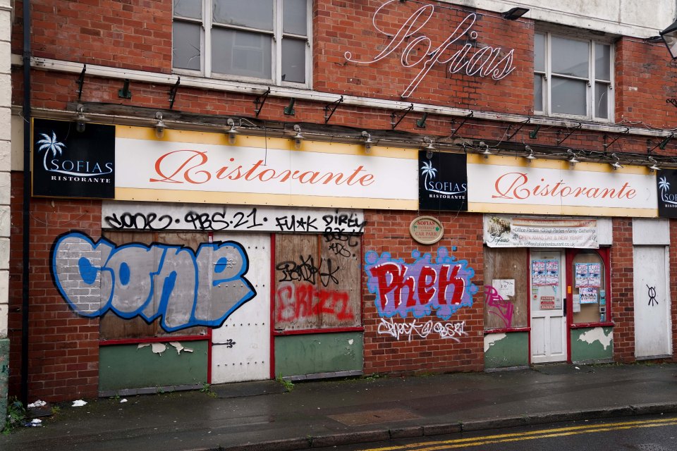 Closed businesses are covered in graffiti