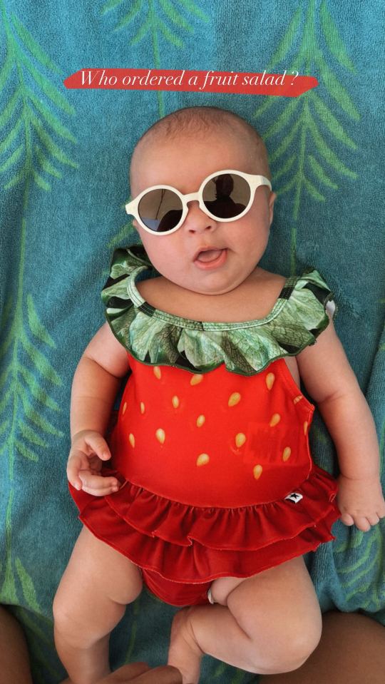 Baby Bambi looked adorable in a strawberry patterned swimsuit