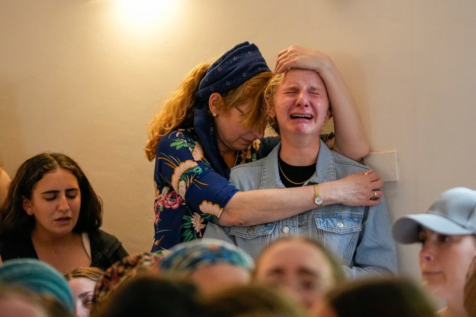 Weeping mourners pictured at the sad farewell