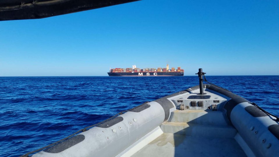 The Dutch cargo ship responsible for saving the teen is pictured in the distance