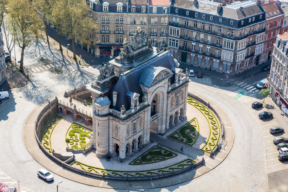 I couldn’t help but laugh at the city’s own Arc de Triomphe — a tiny roundabout with the 17th-century Porte de Paris in the middle