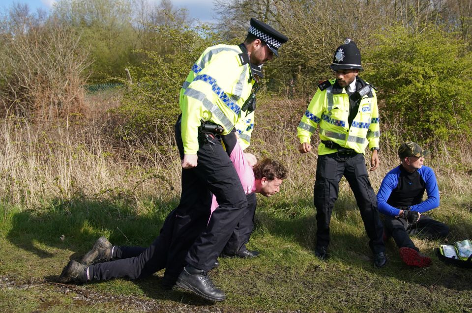 Another person who sparked a delay in the world's most famous race is dragged away by a copper