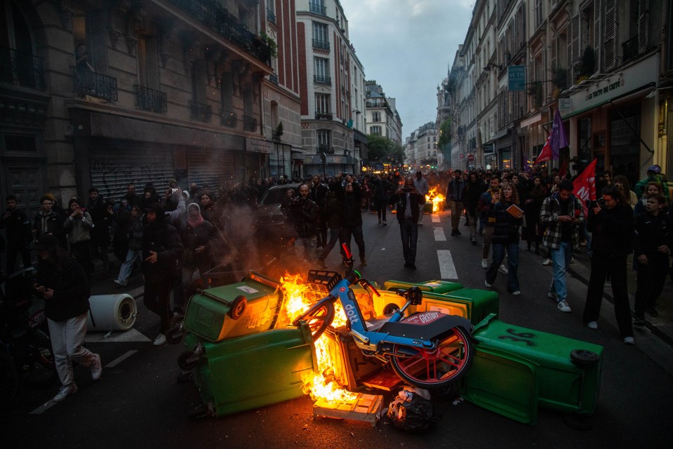 Protesters blocked roads and set fire to bins and rubbish in central Paris