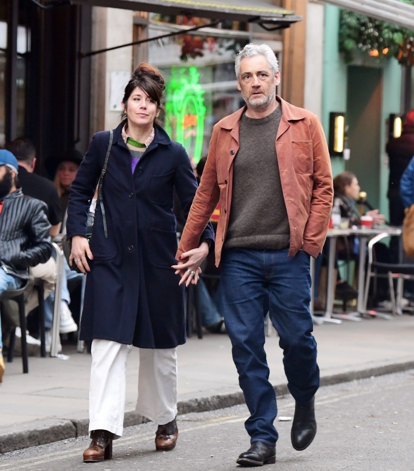 EastEnders star Michael Higgs looked loved-up with his wife Caroline Catz as they walked around London