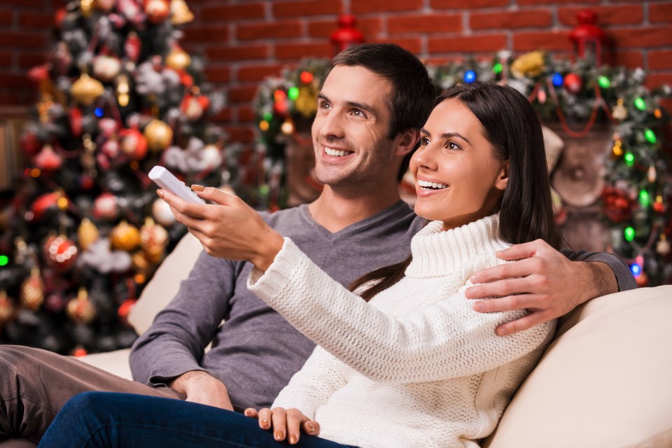 Couple cuddling on the couch during holiday season