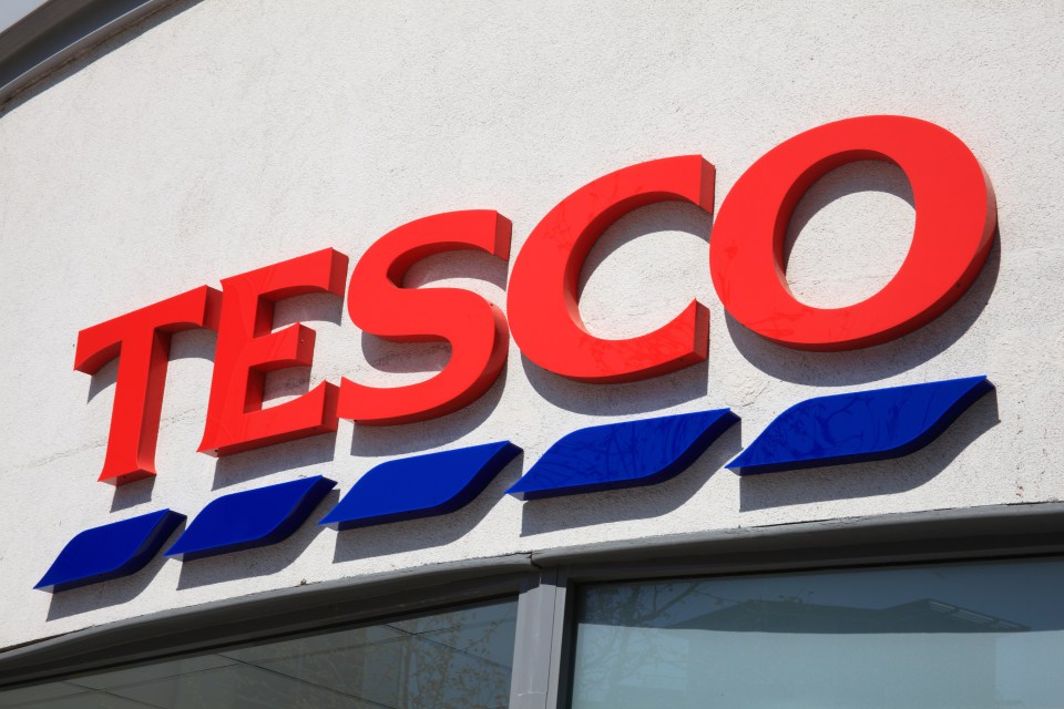 a large red and blue tesco sign on the side of a building