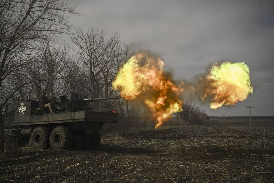 Ukrainian servicemen fire with a S60 anti-aircraft gun at Russian positions near Bakhmut