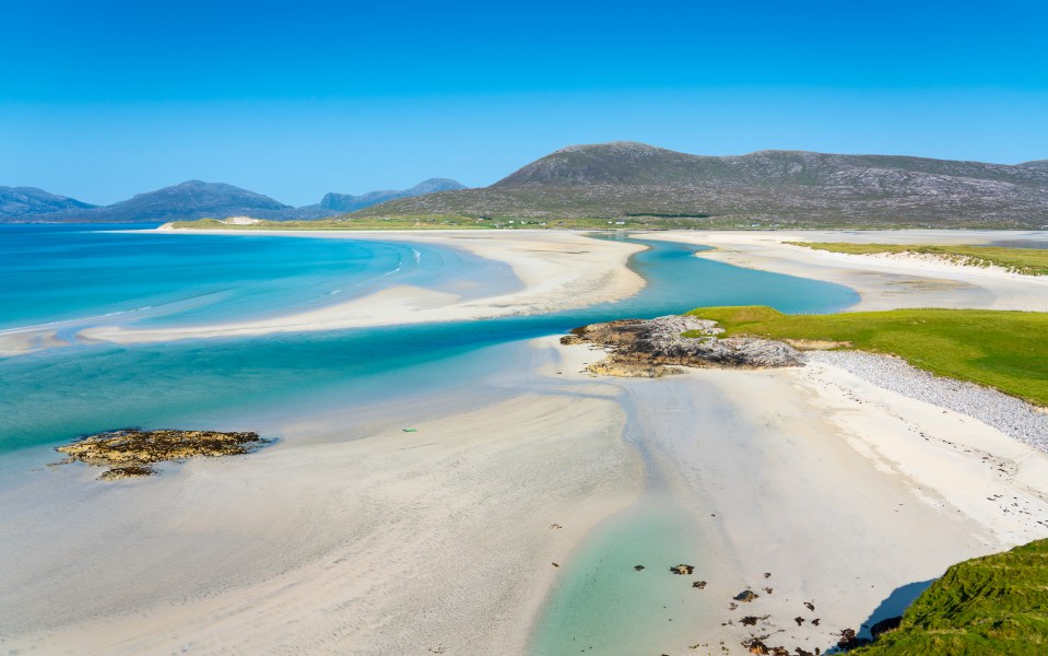 Luskentyre Beach on the Isle of Harris in Scotland has secluded sandy beaches and pristine turquoise