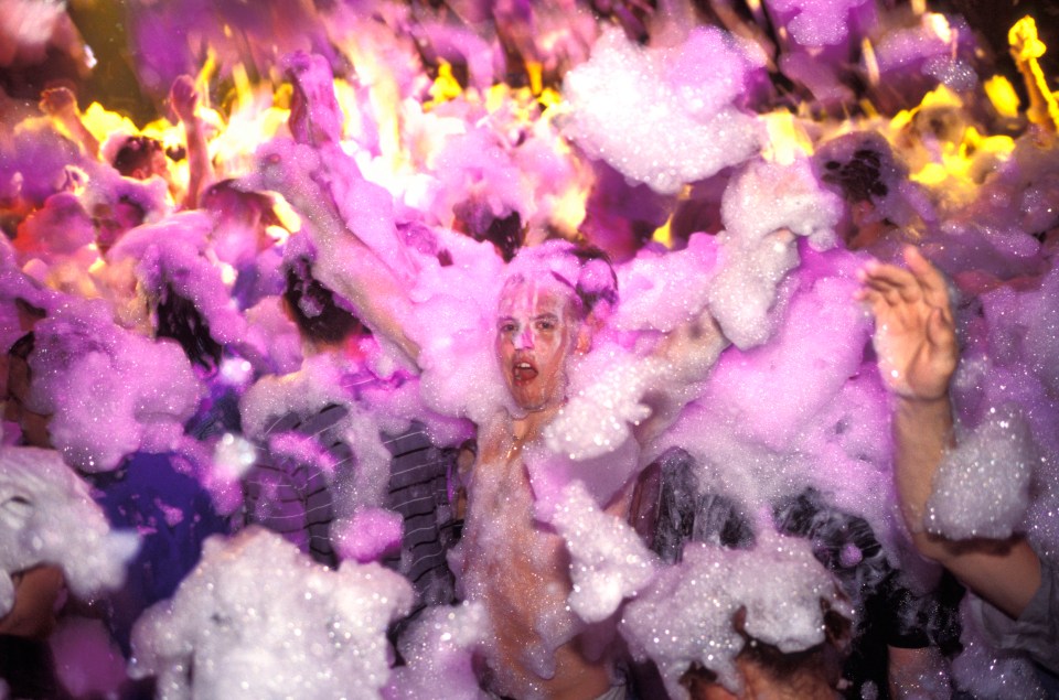 Young clubbers having fun at a foam party in a nightclub in San Antonio, Ibiza