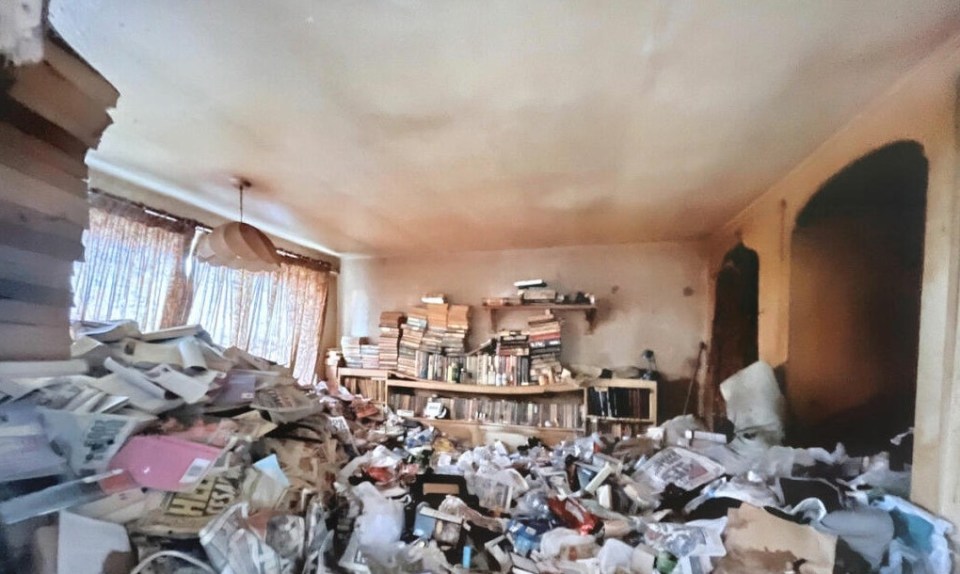 The living room of the three-bedroom detached in Nottingham has old newspapers, books and food wrappers stacked high against the walls