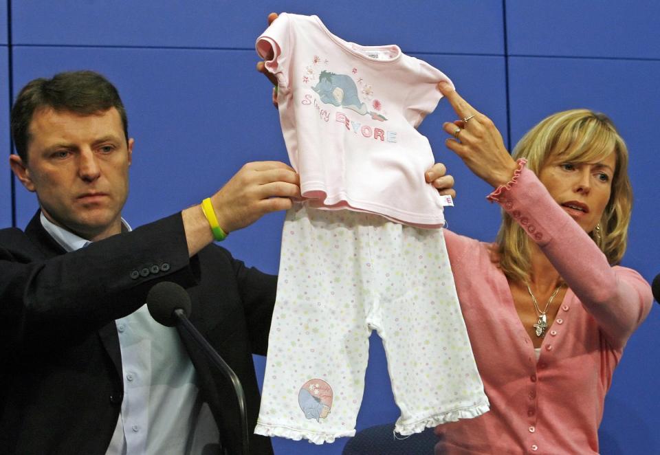 Parents Kate and Gerry McCann holding up pyjamas similar to the ones Maddie was wearing the night she vanished