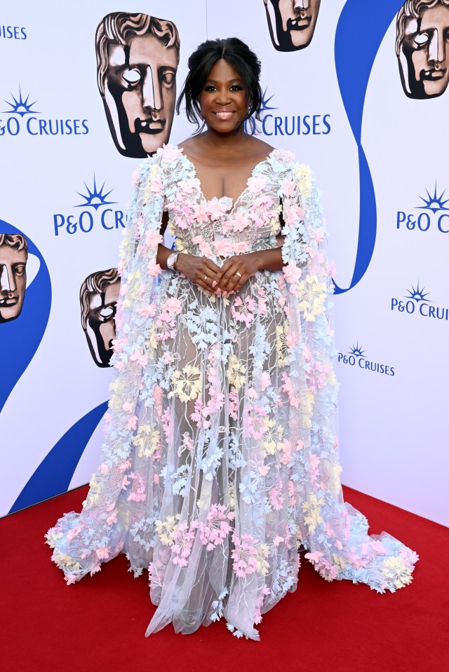 Motsi Mabuse poses at the 2023 BAFTA Television Awards in a flowery white dress