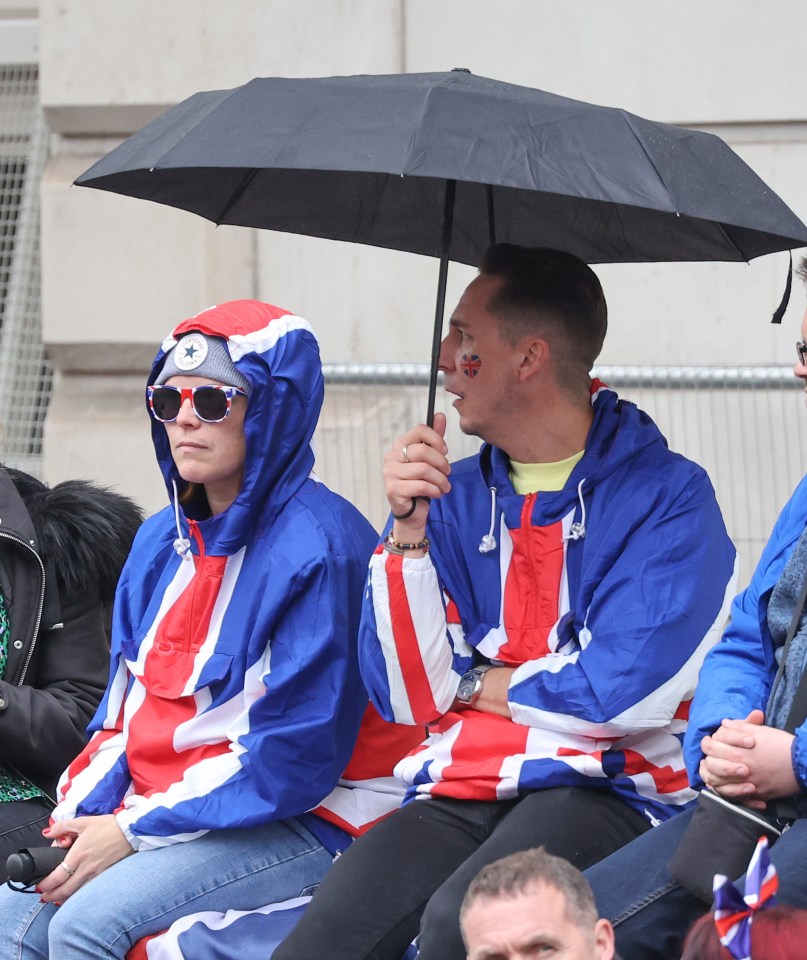 Royal fans keep themselves dry near the Cenotaph in Whitehall, central London