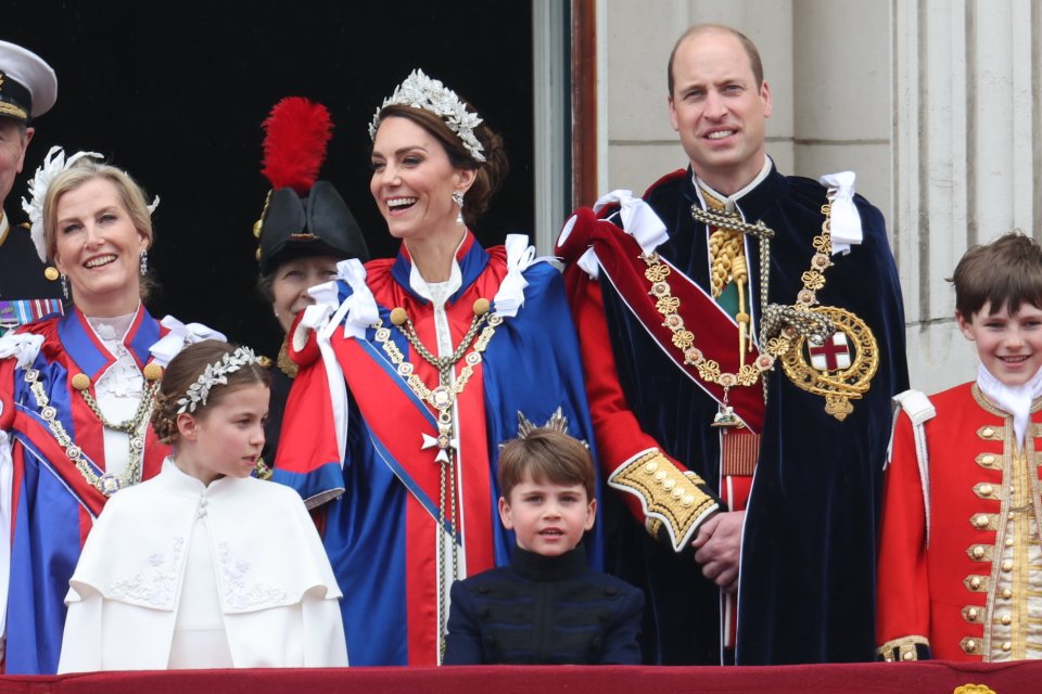 Prince William and Princess Kate beam from the balcony