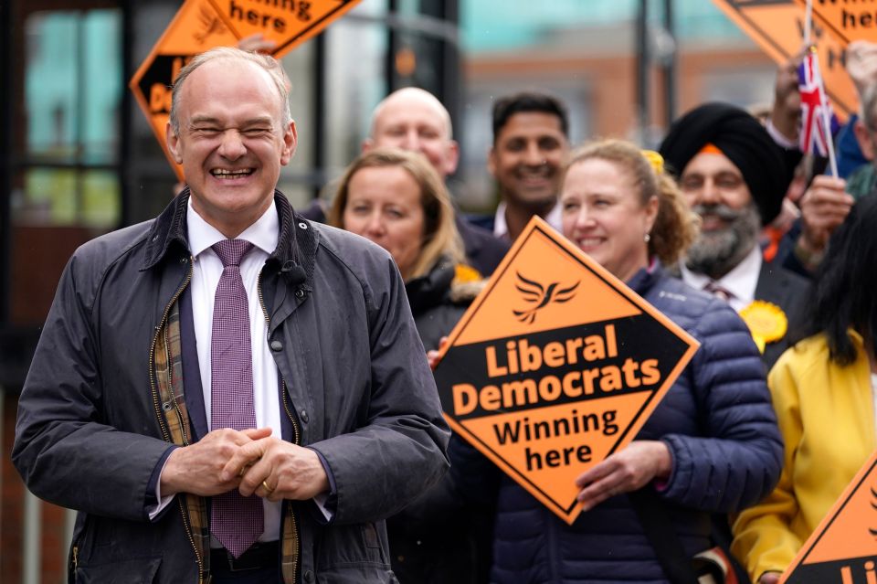 Ed Davey smiles alongside Lib Dem activists in Windsor