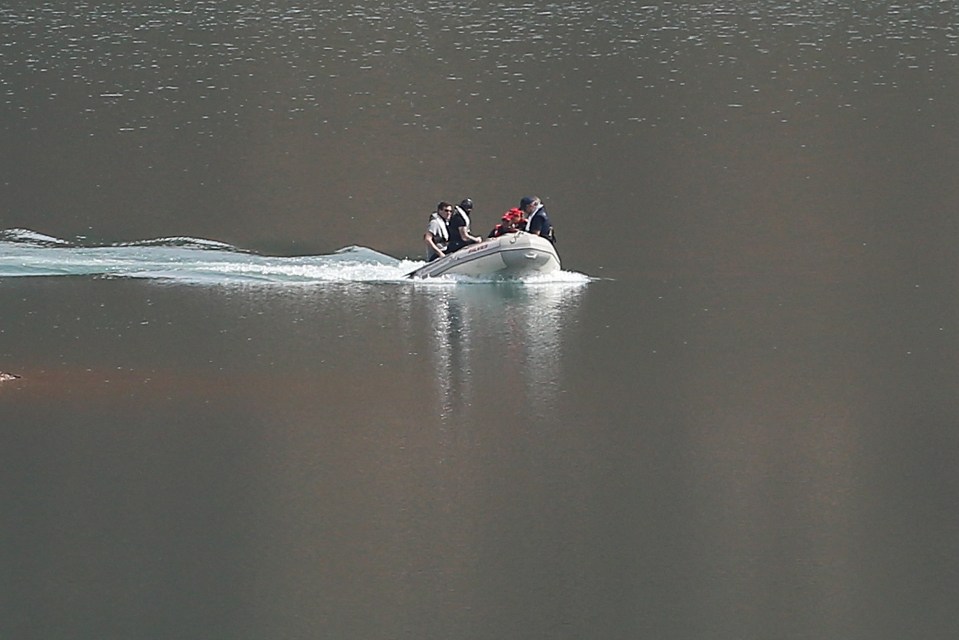 Cops charged up and down the reservoir on boats this week as the hunt intensified