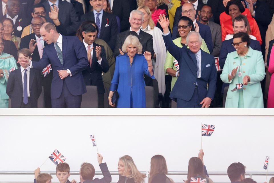 King Charles and Queen Camilla wave to the thousands attending the concert