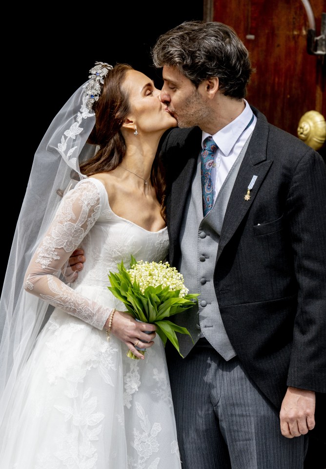 The newly-weds shared a kiss on the steps of the church