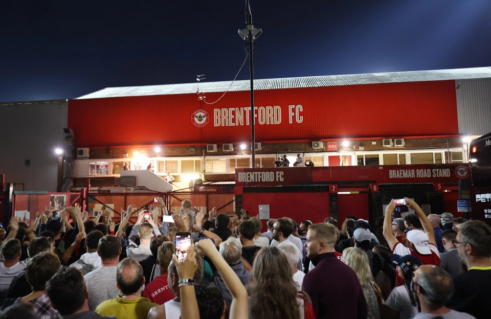 Brentfod fans celebrate outside Griffin Park during the coronavirus pandemic.