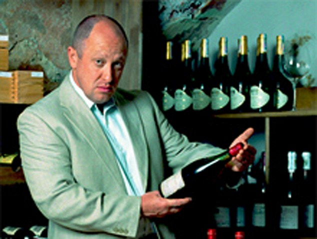 Prigozhin poses with a bottle of wine as he promoted his restaurant business