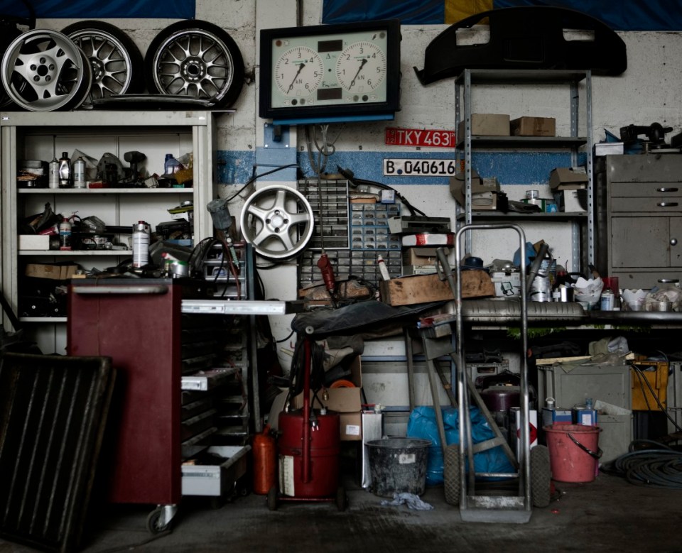 still on location in an messy garage for car repair with lots of details