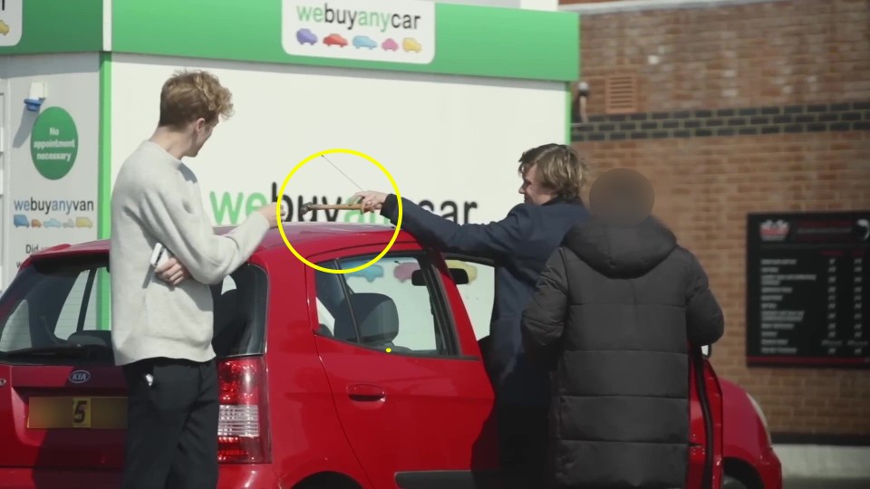 PIC FROM Kennedy News/Josh & Archie (PICTURED: ARCHIE MANNERS PASSING A HAMMER TO JOSH PIETERS AS THE  WE BUY ANY CAR WORKER LOOKS ON) Pranksters keen to test if We Buy Any Car live up to their name were left stunned when they pretended to be gangsters and turned their hatchback into a 'crime scene' - yet the motor firm still bought it. Josh Pieters and Archie Manners, both 29, smeared fake blood over a Kia Picanto and filled the boot with rope, cable ties and even Archie's real hair. A viral video shows the visibly nervous pair parking their vehicle at We Buy Any Car's Putney branch, South London, and telling the worker they 'need to get rid of it quickly'. DISCLAIMER: While Kennedy News and Media uses its best endeavours to establish the copyright and authenticity of all pictures supplied, it accepts no liability for any damage, loss or legal action caused by the use of images supplied and the publication of images is solely at your discretion. SEE KENNEDY NEWS COPY - 0161 697 4266