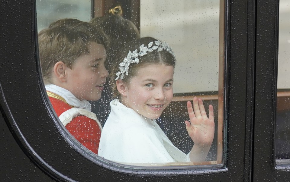 Charlotte waved with George smiling in the carriage after Charles and Camilla were crowned