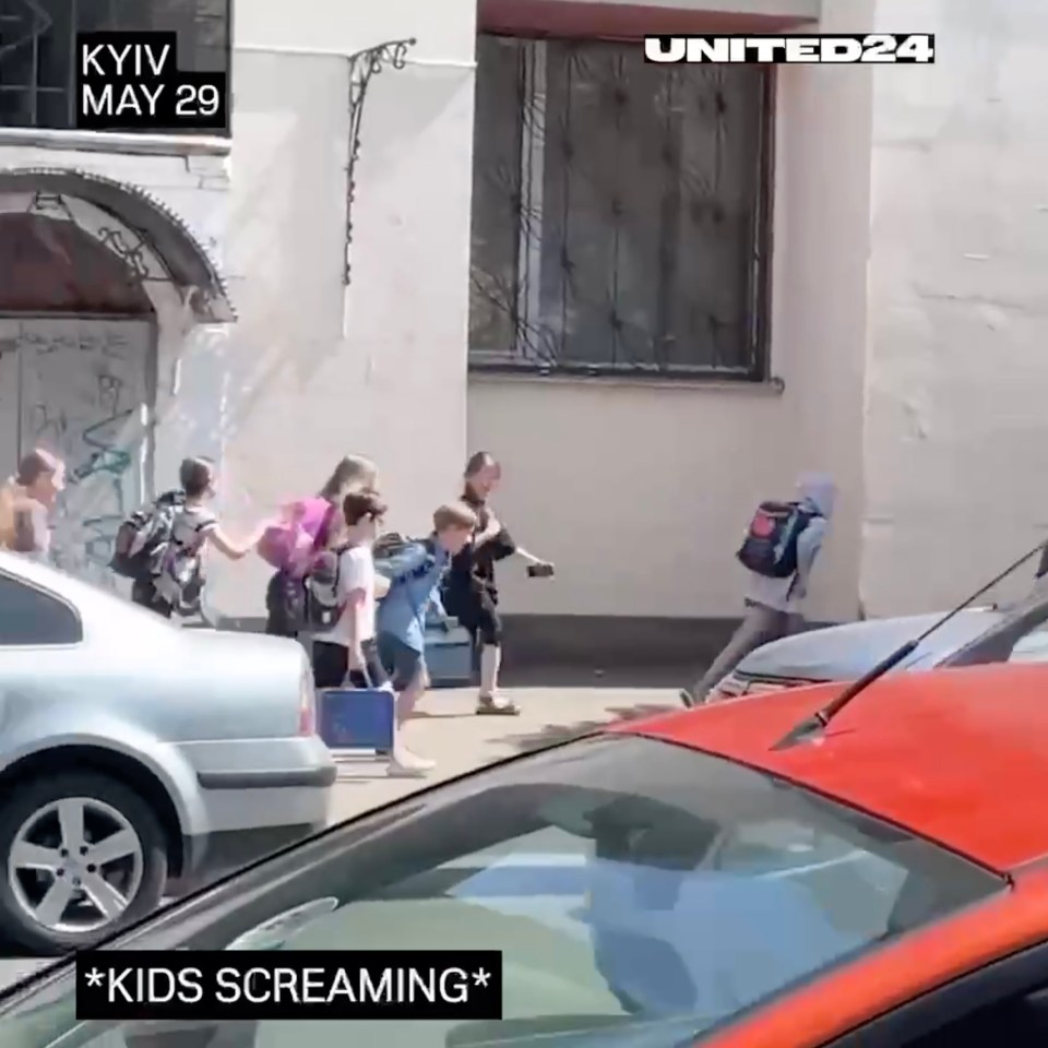 Ukrainian children flee screaming from Vladimir Putin's bombs as they rush to a shelter in Kyiv  on May 29, 2023.