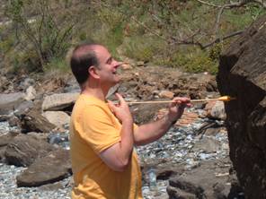 A brave volunteer breaks an arrow on his neck