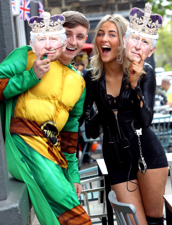 These party goers in Leeds even matched their fancy dress costumes with King Charles masks